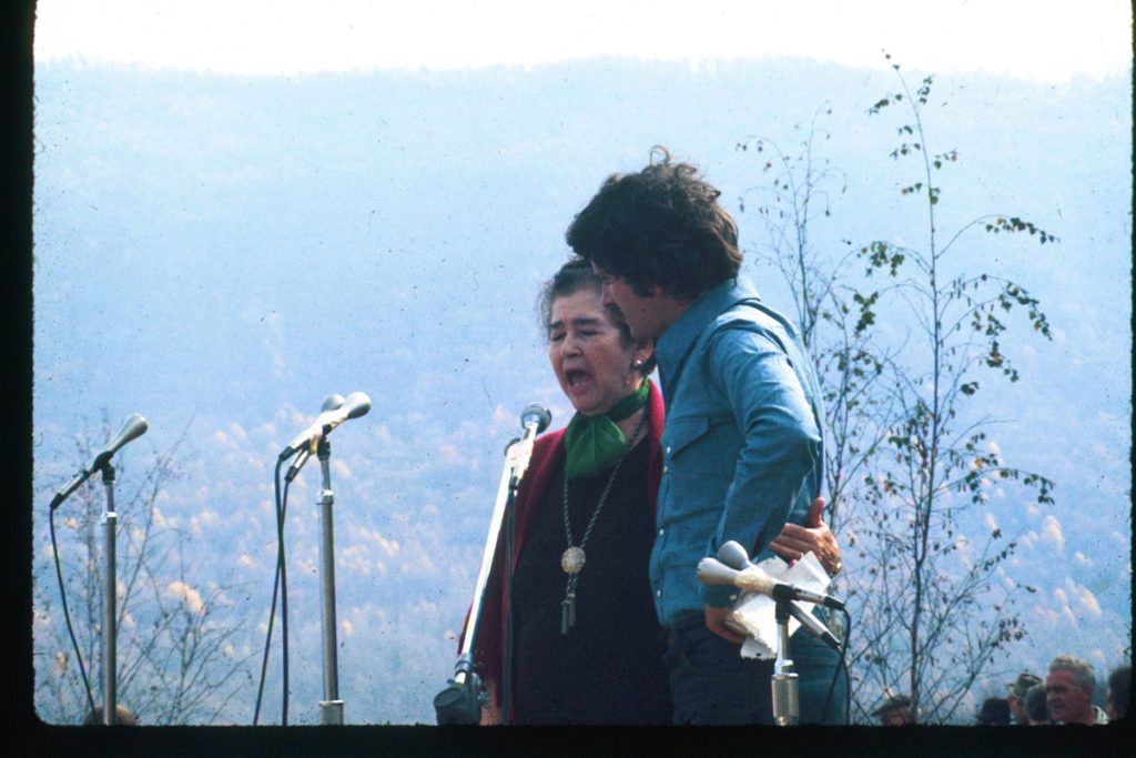 Addie singing with Rich Kirby, mountains in the background