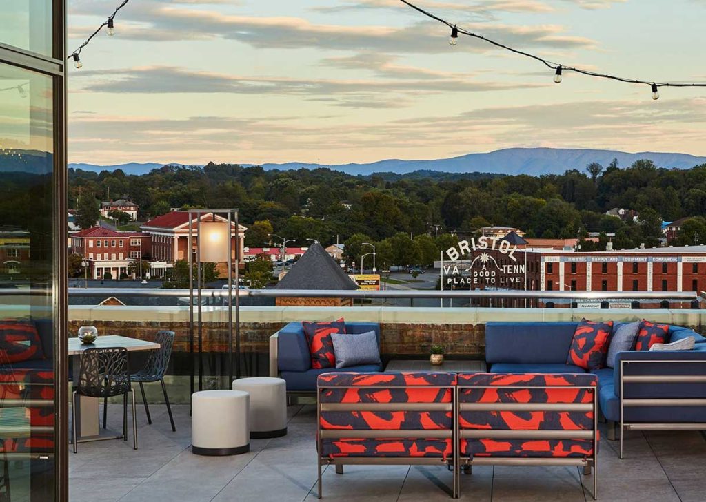 View of Bristol sign and mountain range from Lumac rooftop bar above The Bristol Hotel.

