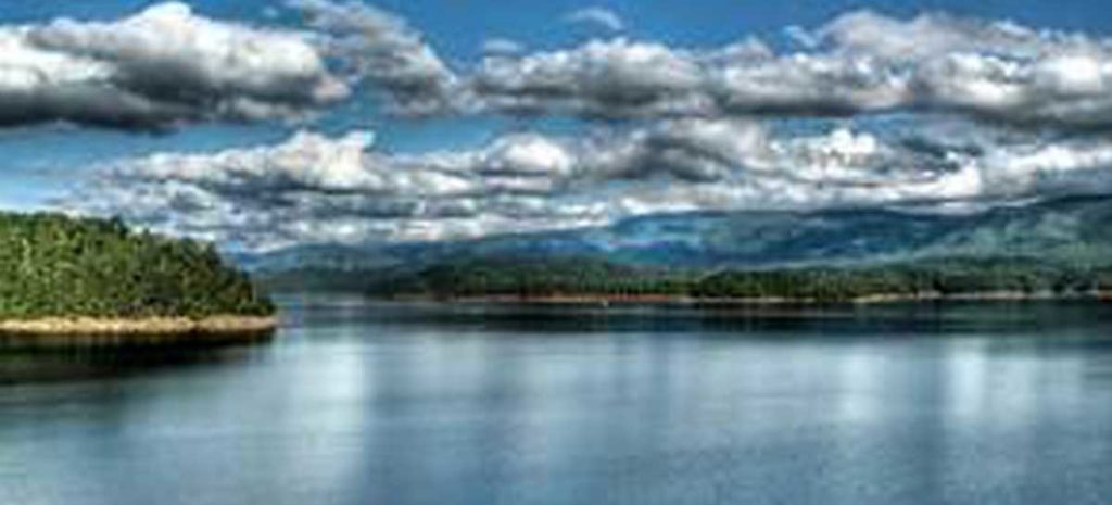 Lovely view overlooking South Holston Lake with fluffy clouds in the sky.
