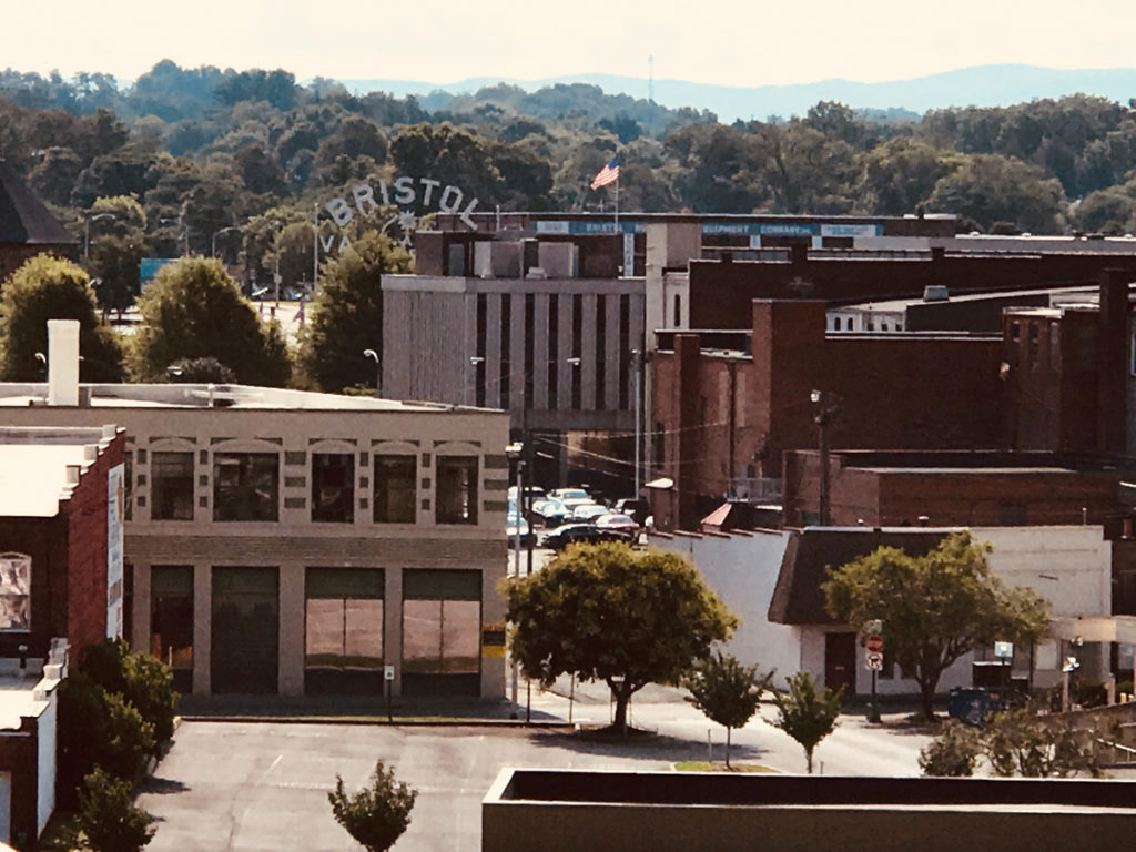 Photo of downtown Bristol with Bristol Sign in the distance.