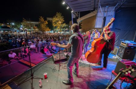 A photo of an acoustic band on stage performing before at crowd at Bristol Rhythm & Roots Reunion.