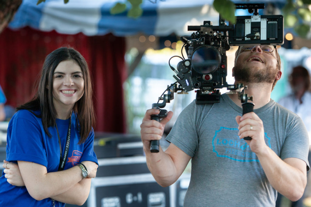 A female student with a cameraman from Loch & Key.