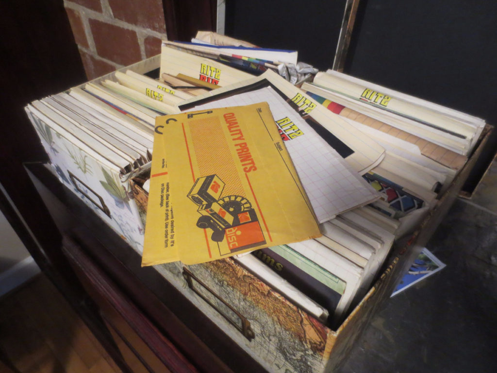 Two boxes overflowing with family photographs