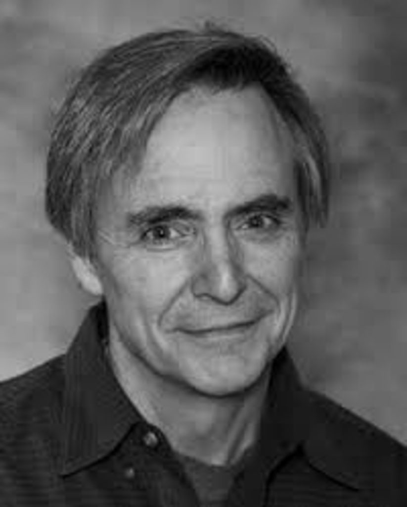 Black and white headshot of author Pope Brock wearing a dark button-down shirt.