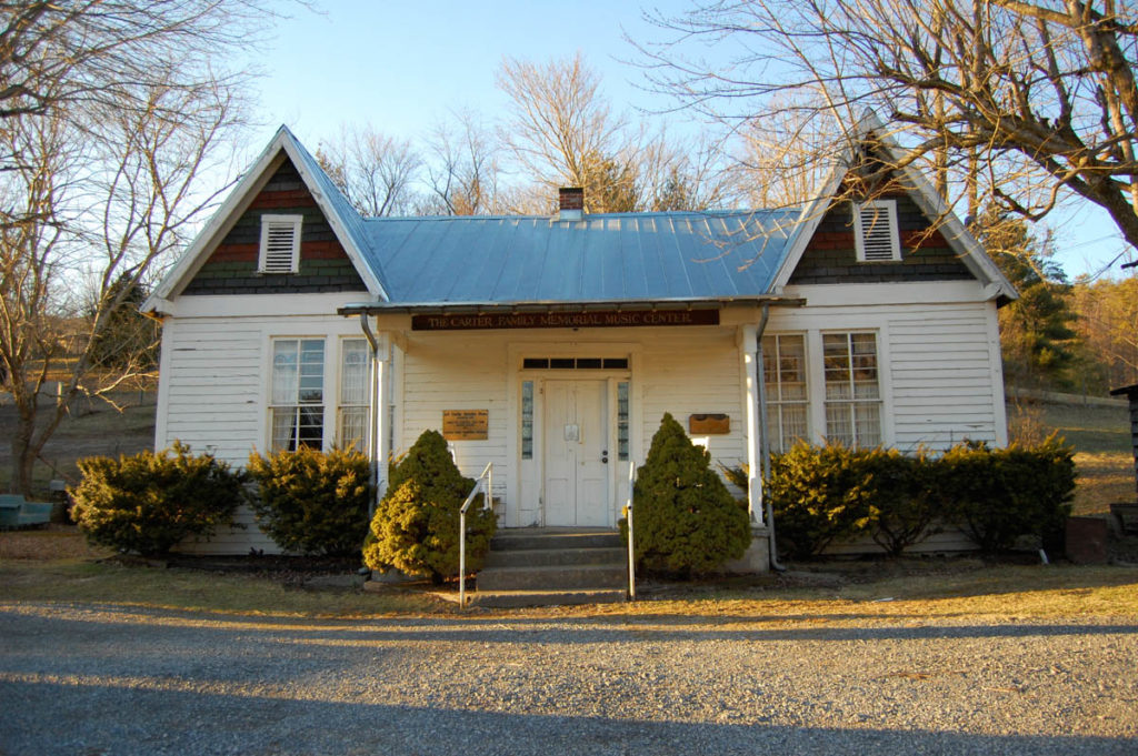 Frontal view of the A.P. Carter Grocery Store, now The Carter Family Museum. It is a small white building with two peaked eaves at each end.