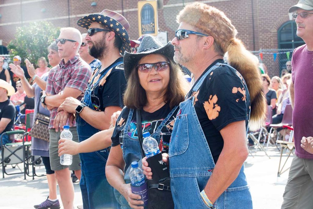 Festival goers holding water bottles.