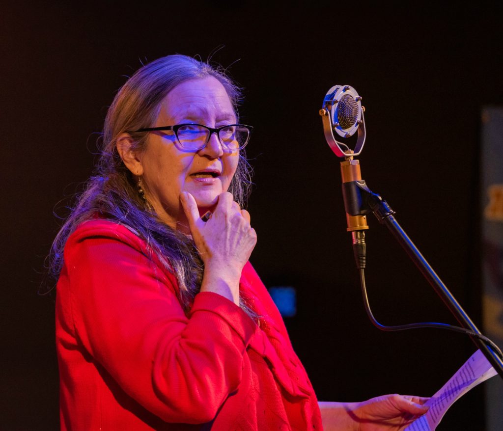 Denise Smith looks out at the audience as she reads her "Heirloom Recipe."
