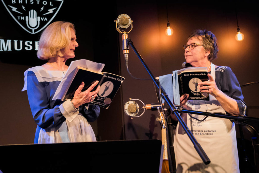 The Blue Stocking Club members were the traditional 1940s club outfits -- a blue dress with a white collar and a Blue Stocking apron -- as they tell the audience about their recipe for Brunswick stew.