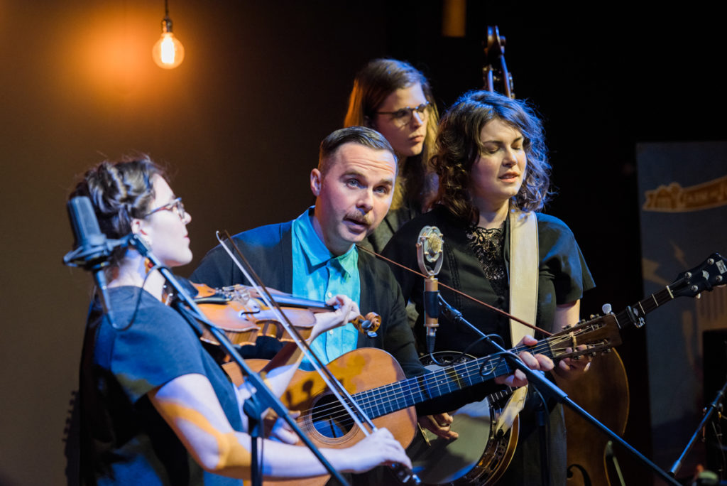 The four members of Bill and the Belles playing fiddle, banjo, guitar, and bass while singing the opening numbers at Farm and Fun Time.