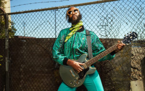 A photo of Fantastic Negrito holding a guitar