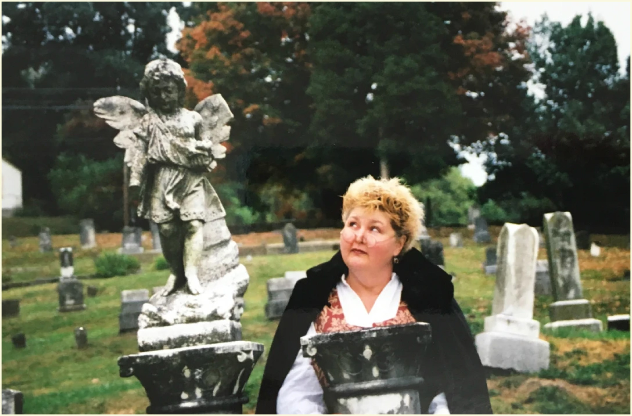 Photo of Donnamarie Emmert in a graveyard.