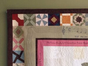 A closeup image of the details of the BCM quilt. The image features a closeup of the colorful, detailed quilted squares. 