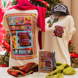 Photo of 2024 festival shirt, weekend pass envelope and trucker hat.