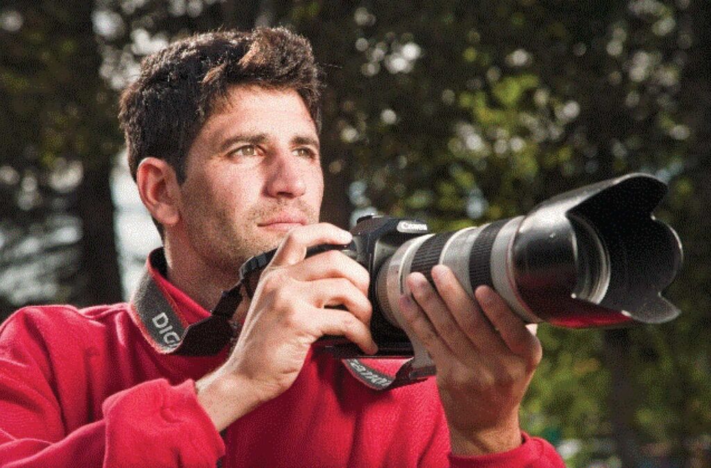 A photo of author Daniel Seddiqui holding a camera.