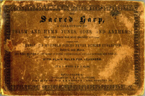 The cover of the original "Sacred Harp" hymn book. It is old and worn, reading "The Sacred Harp, a Collection of Psalm and Hymn Tunes, Odes, and Anthems; selected from the most eminent authors, together with nearly one hundred pieces never before published. Suited to most metres, and well adapted to Churches of every denomination, singing schools, and Private [word obscured]. With Plain Rules for Learners. By B.F. White and E.J. King
