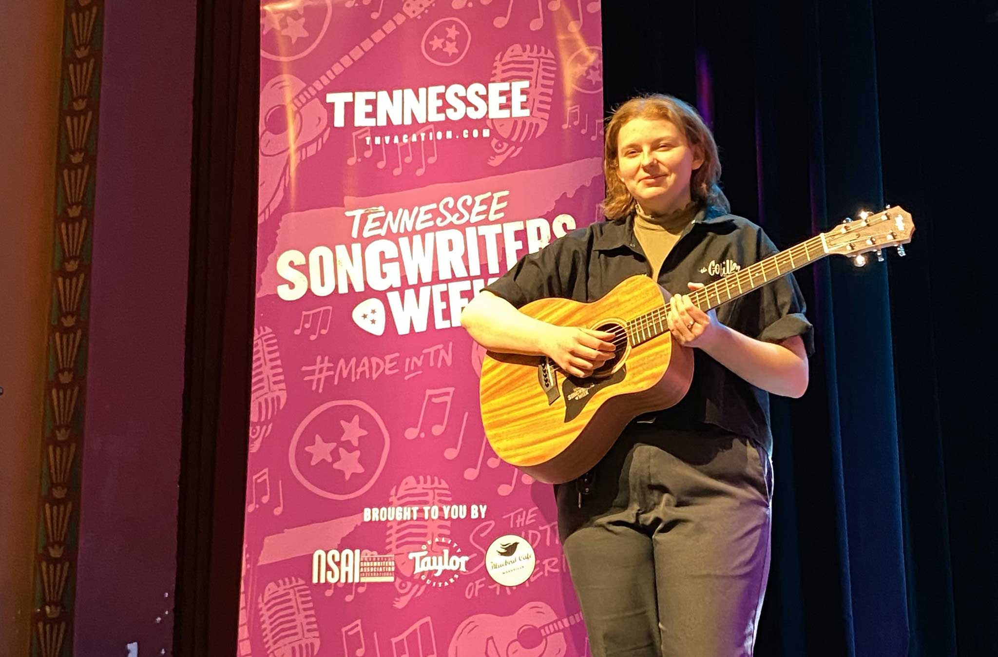 Claire Childress holding a Taylor guitar.