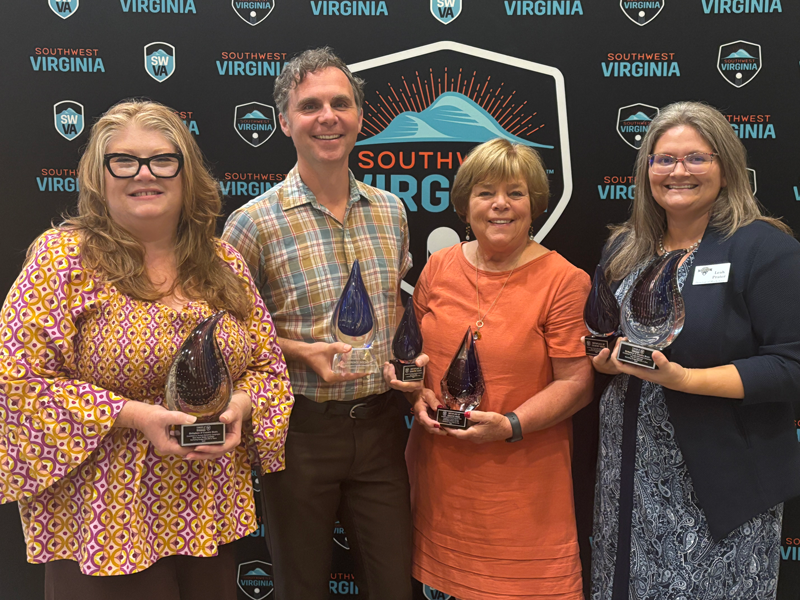 Photo of BCM staff Charlene Baker, Kris Truelsen, Leah Ross and Leah Prater holding trophies.