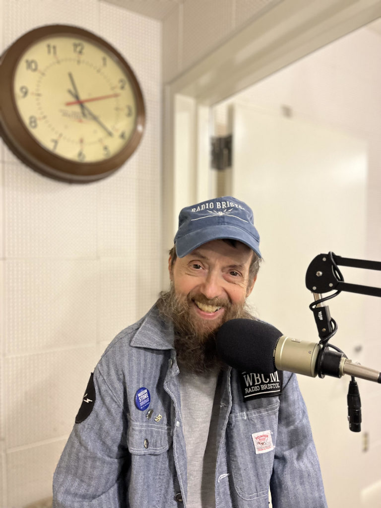 Photo of Lawrence Inscho behind the mic at Radio Bristol.